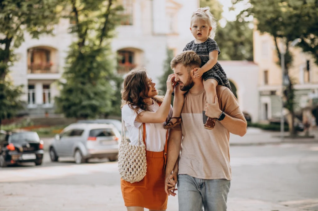 In the image a family walking through the city