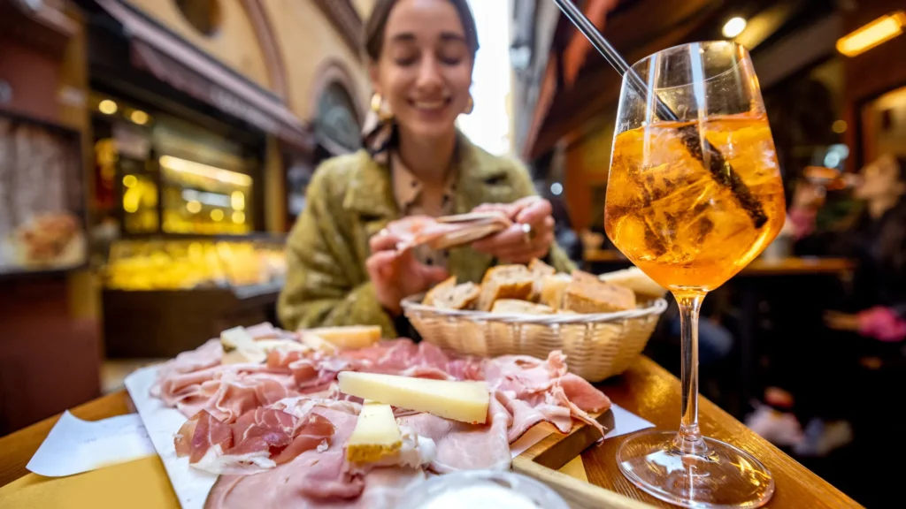 Nell'immagine una ragazza che fa aperitivo in un bar del quartiere