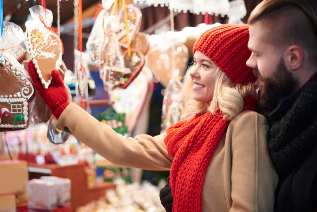 The image shows a couple at the Christmas markets.